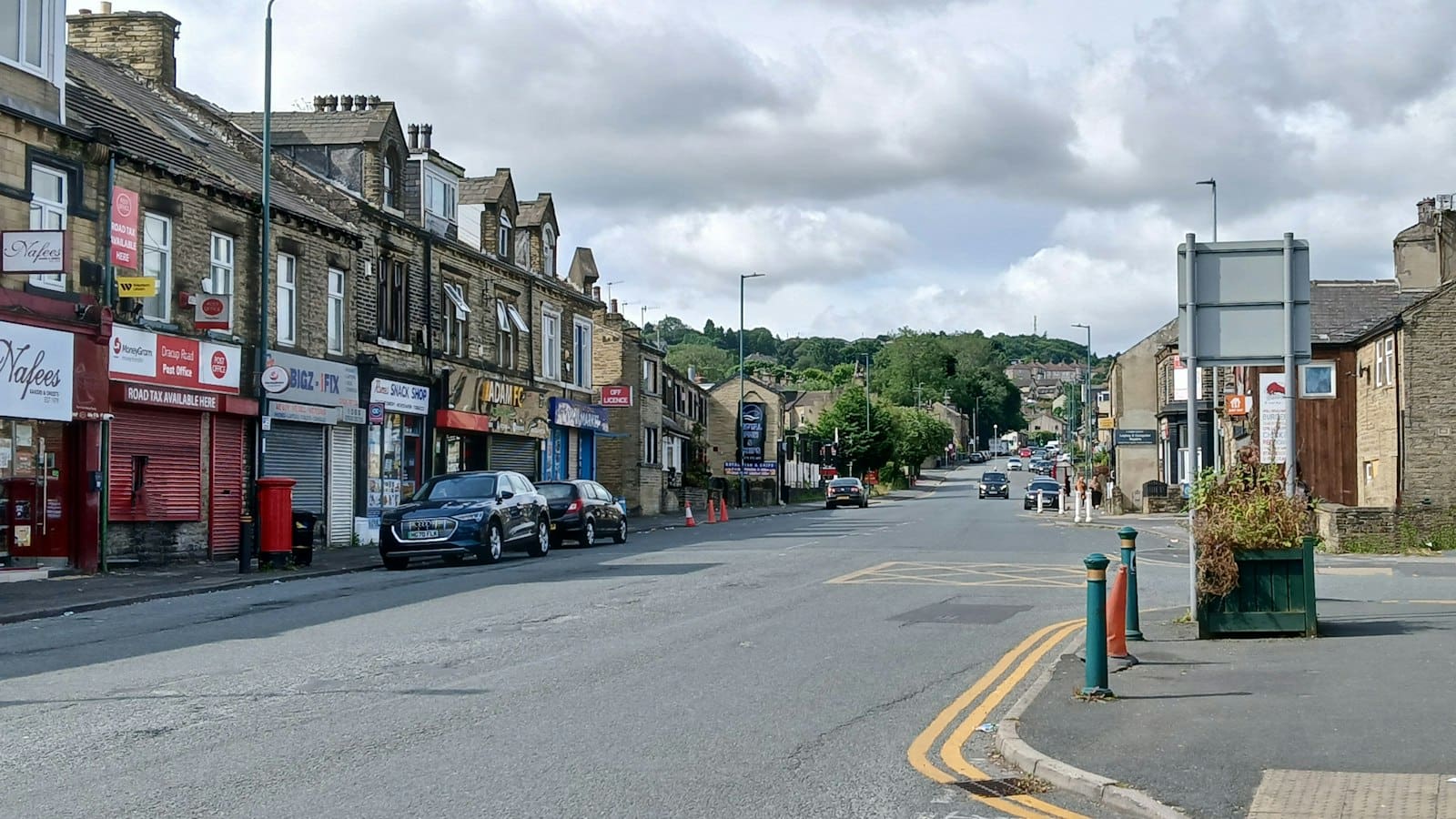 Stone-built shops and houses on a street in Great Horton, Bradford
